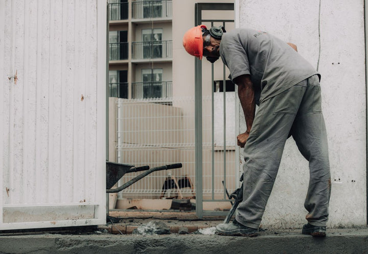 Worker operating a jackhammer on a construction site