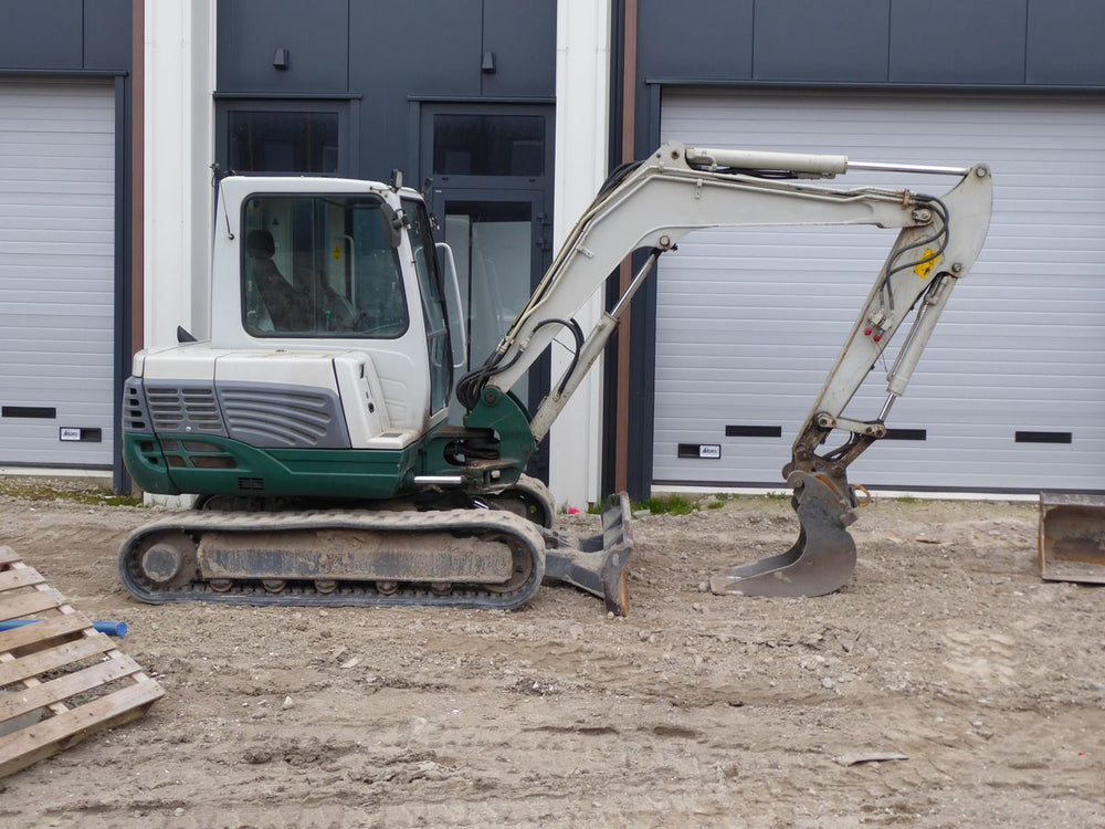 Compact excavator on a construction site