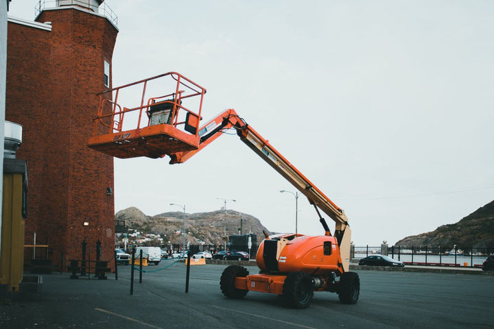 Orange articulating boom lift outdoors